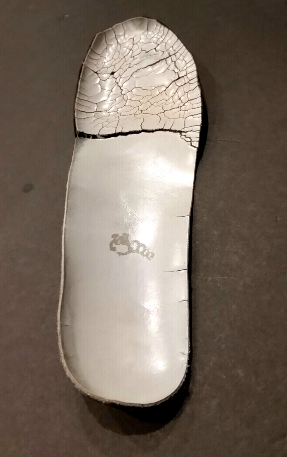 Thinning and worn top cover on orthotic